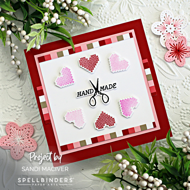 hand made square card with cross stitched hearts in a circle in reds and pinks created with new card making products from Spellbinders 