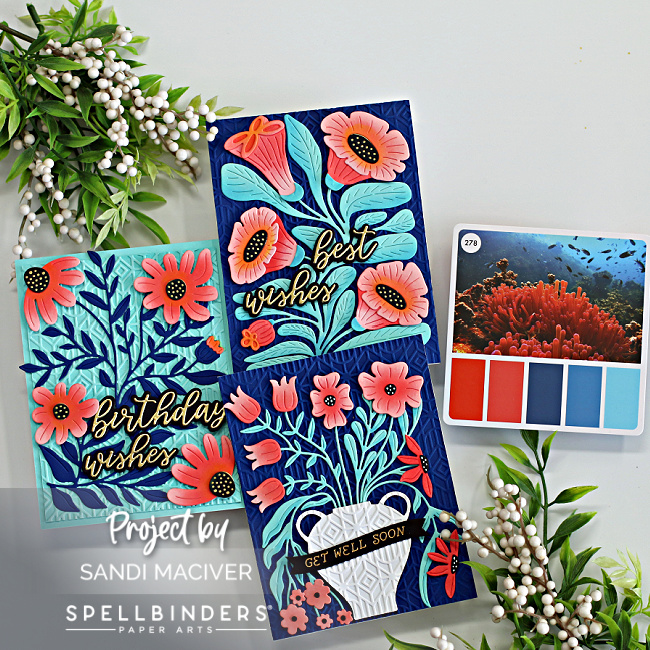 three hand made cards with dark blue background and orange flowers created with new card making products from Spellbinders