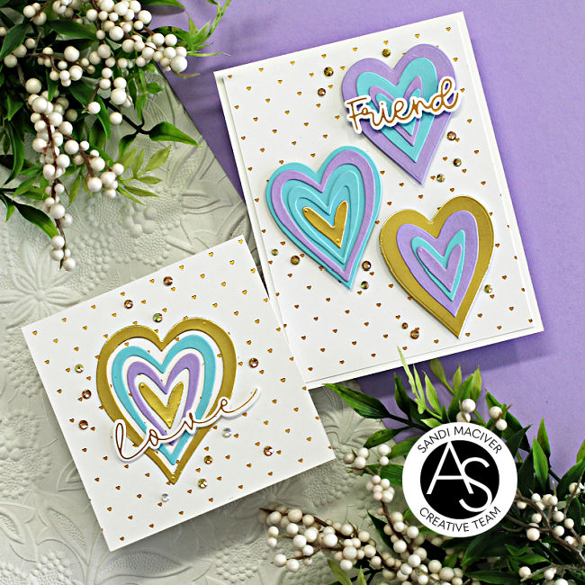 two white hand made cards with small gold hearts foiled in the background and larger die cut hearts embellishing the centers created with new card making supplies from Alex Syberia Designs