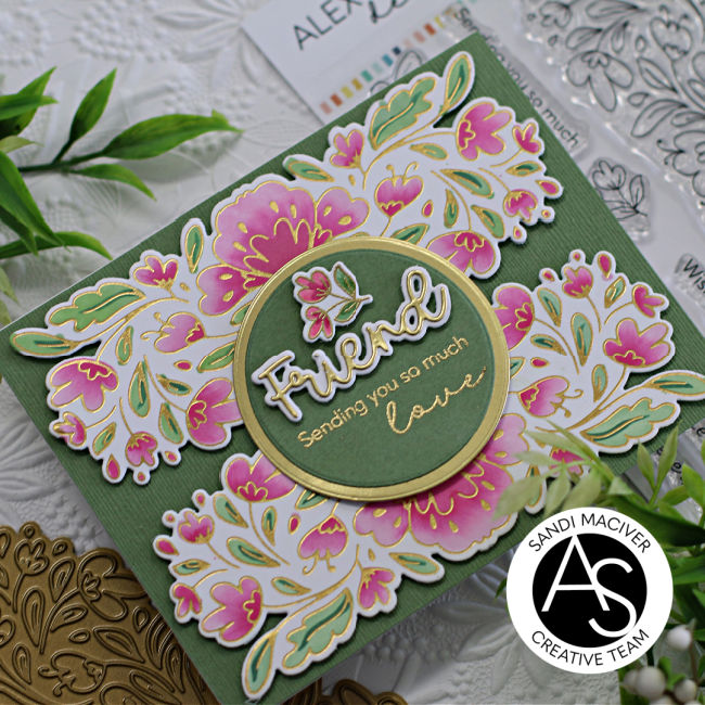 pink and green hand made card with a border of flowers top and bottom and a green circle with the sentiment in the center created with new card making products from Alex Syberia Designs