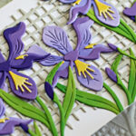 white slimline card covered in purple die cut Iris created with new card making supplies from Spellbinders
