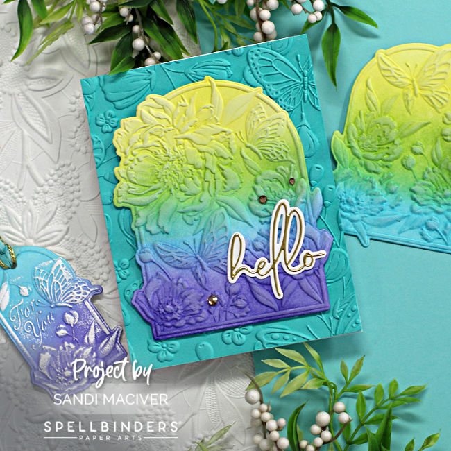 hand made teal colored card peonies and butterflies embossed on a arched insert in purple, blue, green and yellow created with new card making supplies from Spellbinders 