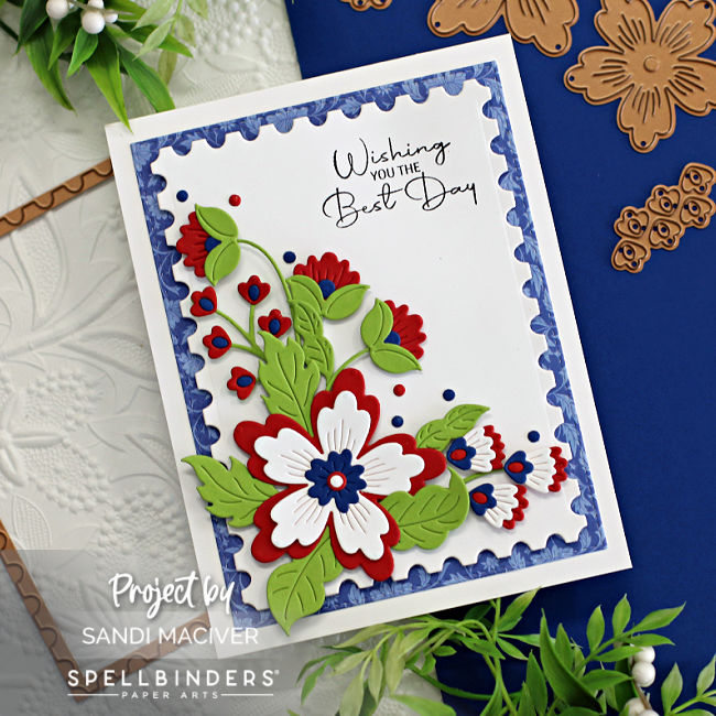 hand made 4th of July card in red white and blue with a blue die cut background and red white and blue flowers, created with card making dies from Spellbinders