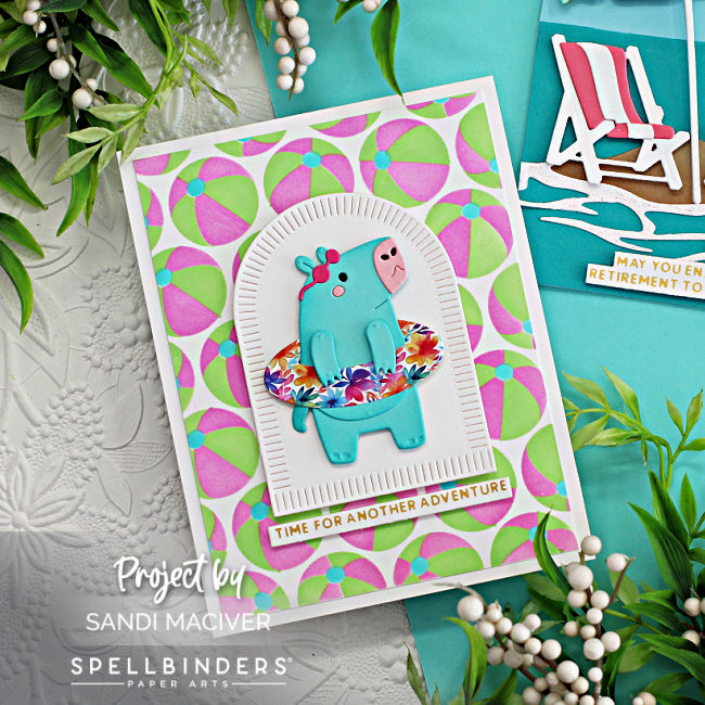 beach themed card with a pink and green beach ball background with a hippo in a wadding pool created with new card making products from Spellbinders