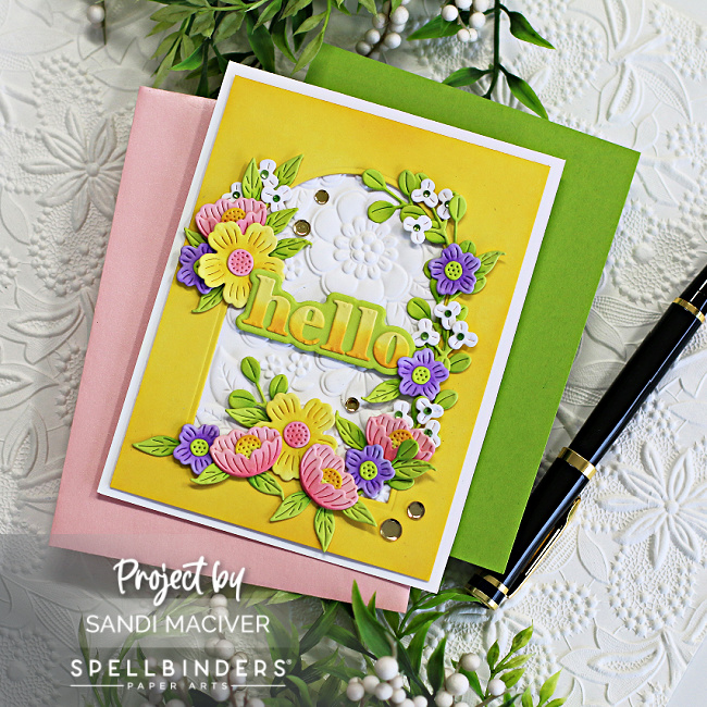 hand made white and yellow card with an arch cut in the center surrounded by pink yellow and purple die cut flowers created with new card making supplies from Spellbinders 