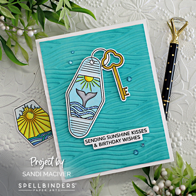 hand made greeting card with a beach themed key fob, on a waivy ocean feel embossed background created with new card making supplies from Spellbinders 