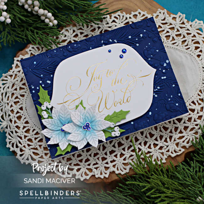 hand made Christmas card with a Dark Navy embossed background a white mid section with a beautiful copperplate font sentiment and embellished with white poinsettia die cuts and dark green foliage cut using new card making supplies from Spellbinders