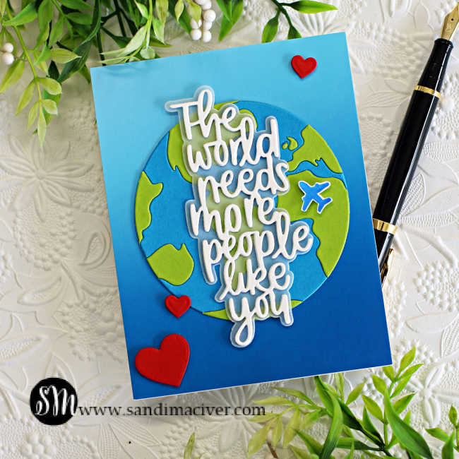 hand made card with a two tone blue background, a die cut green and blue world with a white sentiment overlay created with new card making products from Simon Says Stamp