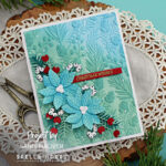 blue and green christmas card with blue poinsettias, red flowers and white berries created with new card making products from Spellbinders