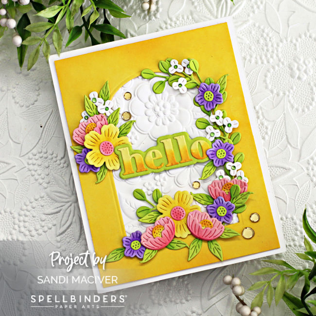 hand made white and yellow card with an arch cut in the center surrounded by pink yellow and purple die cut flowers created with new card making supplies from Spellbinders