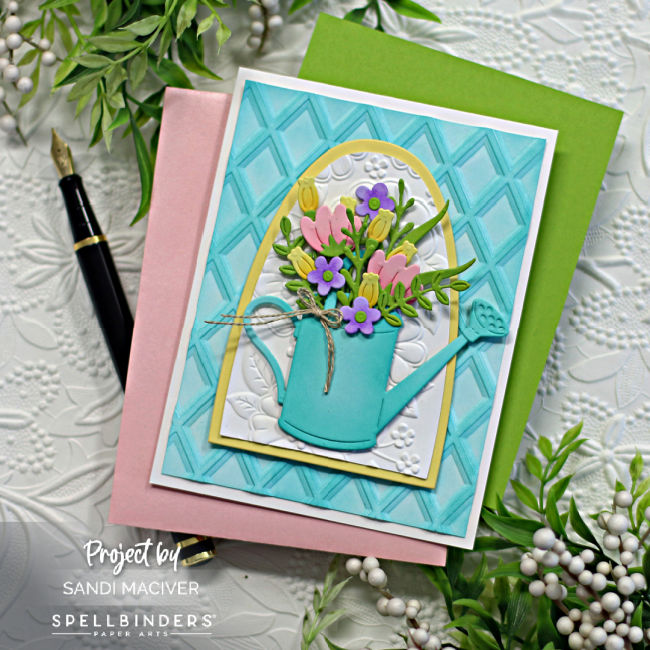 teal and yellow hand made greeting card with a teal watering can and pink, yellow and purple flowers inside, created with new card making supplies from Spellbinders