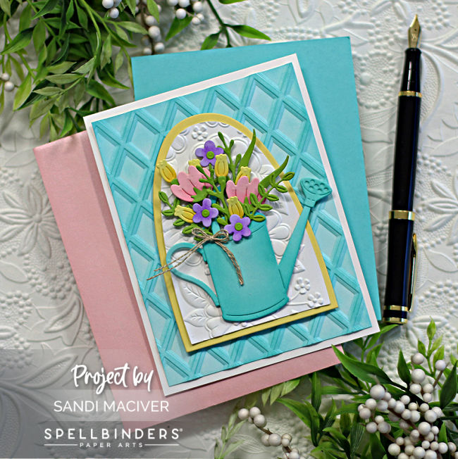 teal and yellow hand made greeting card with a teal watering can and pink, yellow and purple flowers inside, created with new card making supplies from Spellbinders