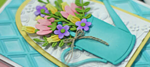 teal and yellow hand made greeting card with a teal watering can and pink, yellow and purple flowers inside, created with new card making supplies from Spellbinders