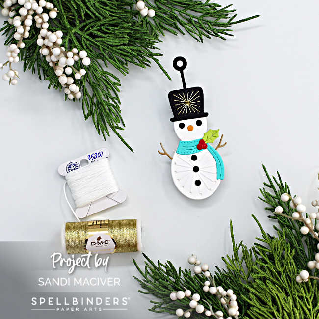 die cut snow man ornament with a stitched tummy and hat and a blue scarf