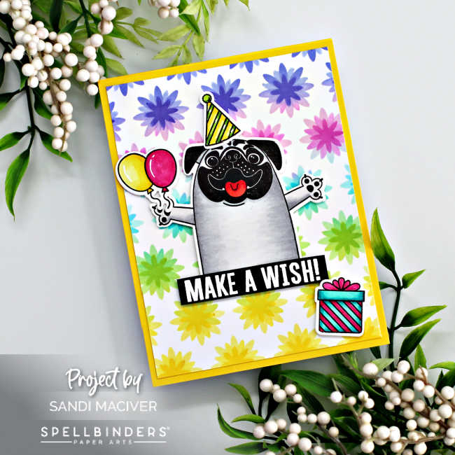 hand made birthday card with a pug holding balloons and wearing a party hat with a rainbow stenciled background