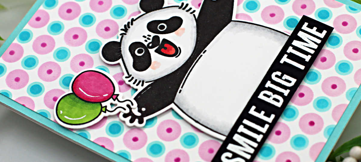 hand made birthday card with a celebrating panda holding balloons and a drink with a pink and blue polka dot background