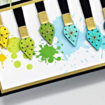 hand made slimline card with a rainbow of ink splatters and 9 rainbow paint brushes