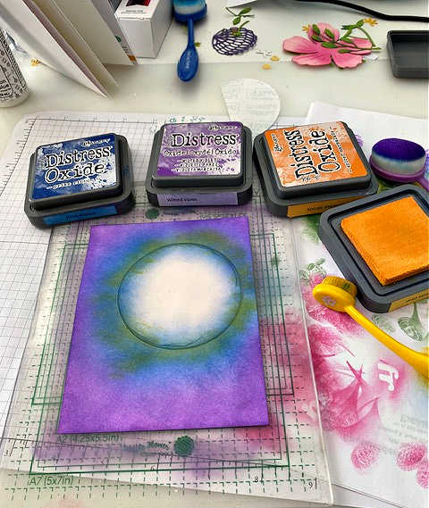 picture of the masking technique where the moon is covered with sticky paper while ink blending in purple and blue around it