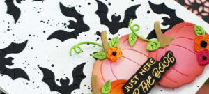 hand made white card with black bats all over it decorated with pink and orange pumpkins and flowers