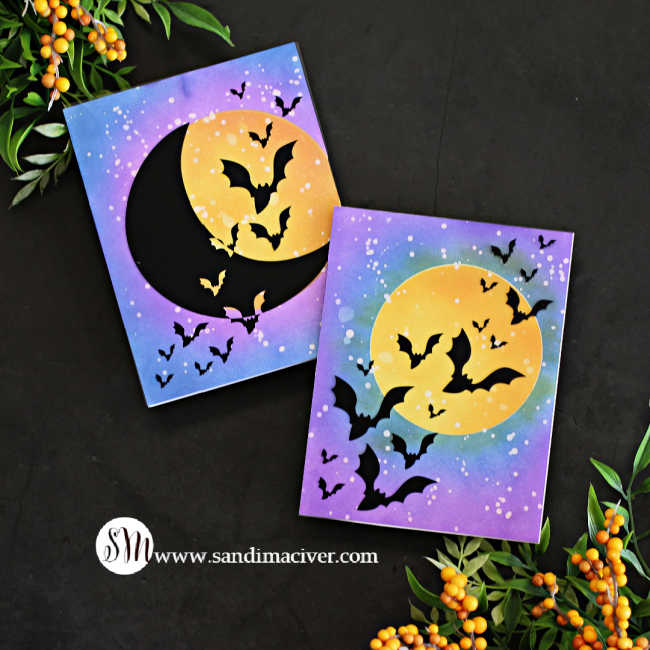 hand made Halloween cards with a big yellow moon and a blue and purple sky with a flock of bats flying across it