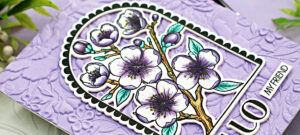 purple embossed hand made card with a center arch full of purple colored flowers