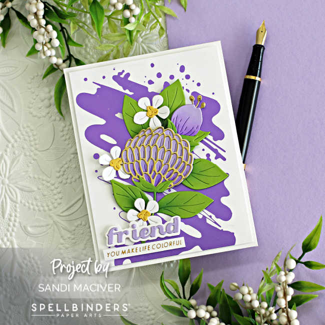 hand made card with a purple splash on white background, a die cut purple and gold flower and small white flowers