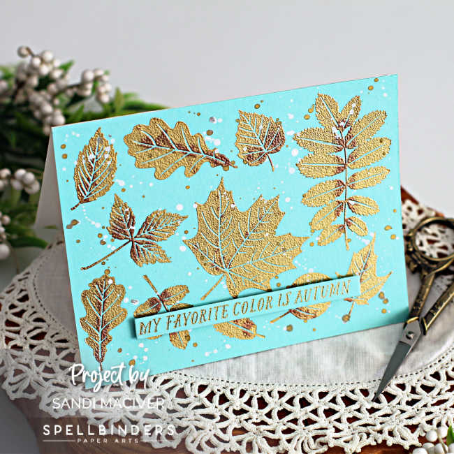 Pale blue card with gold and brass embossed leaves