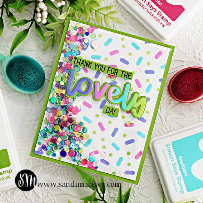 hand made shaker card with a stenciled confetti background in purple, pink, turquoise and green and a rainbow lovely sentiment in the same colors