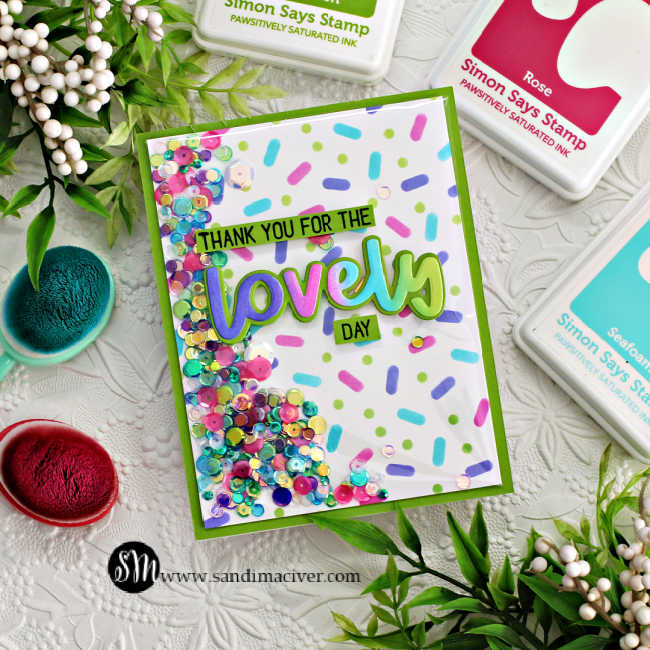 hand made shaker card with a stenciled confetti background in purple, pink, turquoise and green and a rainbow lovely sentiment in the same colors