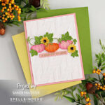 handmade fall card with a white embossed background and pink and orange die cut pumpkins decorated with yellow sunflowers and green leaves