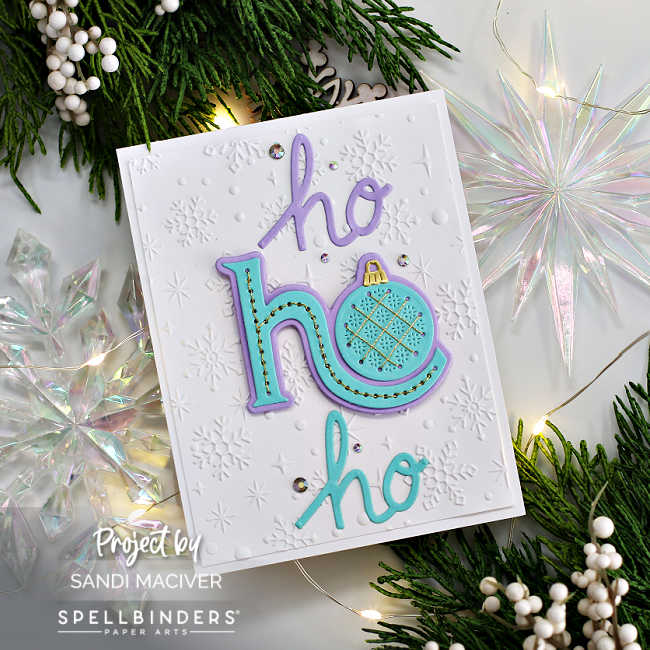 hand made christmas card with the words ho ho ho die cut in blue and purple with the large center one stitched.