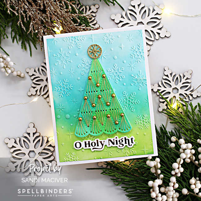 Hand made Christmas card with a watercolor stitched Christmas tree over a blue and green embossed background.