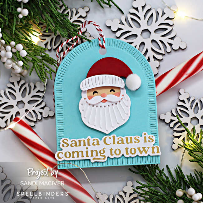 Teal blue hand made santa Christmas parcel tag with a stitched santa and gold lettered sentiment