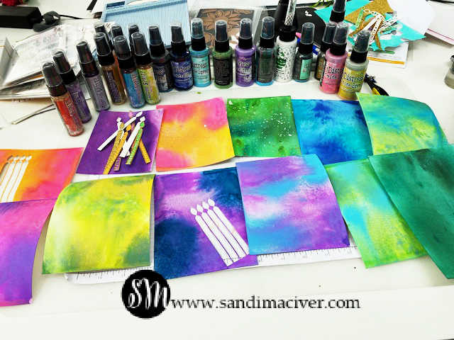 picture of brightly colored sprayed watercolor paper for backgrounds on cards