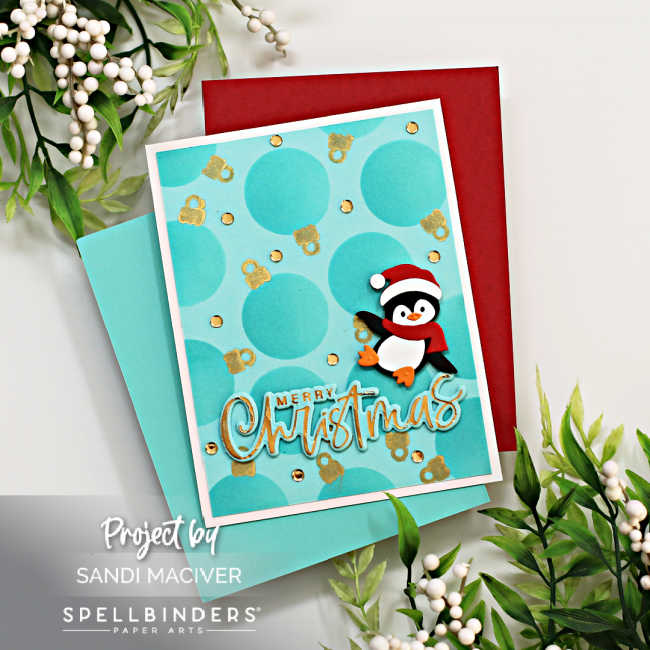 hand made christmas card with stenciled ornaments in the background and a cute penguin wearing a scarf and santa hat