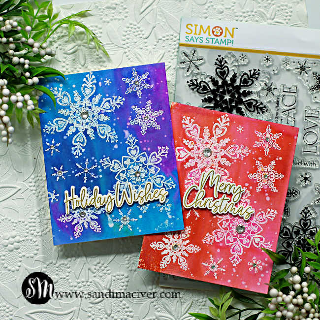 two hand made christmas cards covered in white snowflakes one in blues and one in pinks