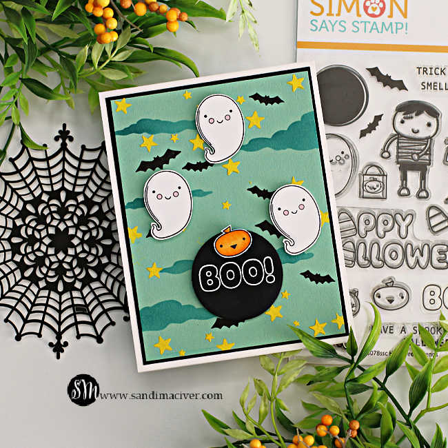 hand made Halloween card with a mint green background, blue clouds and yellow stars with three ghosts