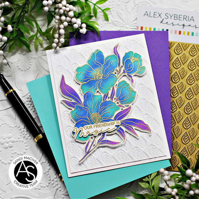 hand made friendship card with blue and green flowers with purple leaves on a white embossed background