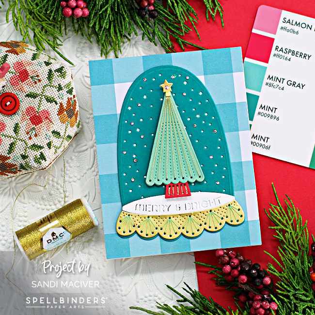 hande made christmas card in teals and green with a stitched christmas tree enclosed in a cloche on a teal and white plaid background