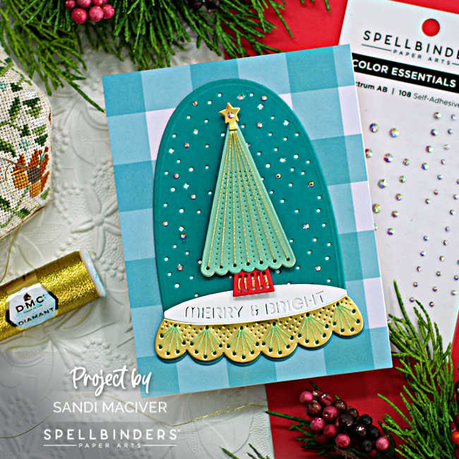 hande made christmas card in teals and green with a stitched christmas tree enclosed in a cloche on a teal and white plaid background