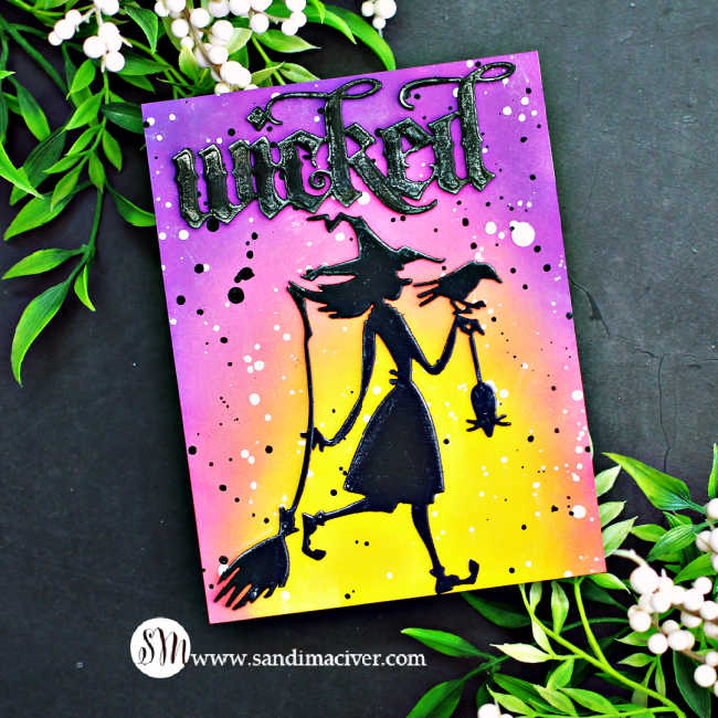 hand made Halloween card with a purple, pink and yellow ink blended background and a witch carrying a rat and a crow and her broom, in black silhouette and the word wicked at the top in gothic lettering