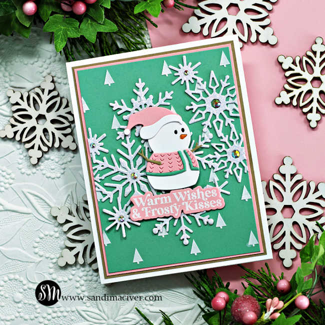 Mint Green and soft pink hand made cards featuring die cut snowflakes and tiny snowmen wearing pink and green sweaters and hats