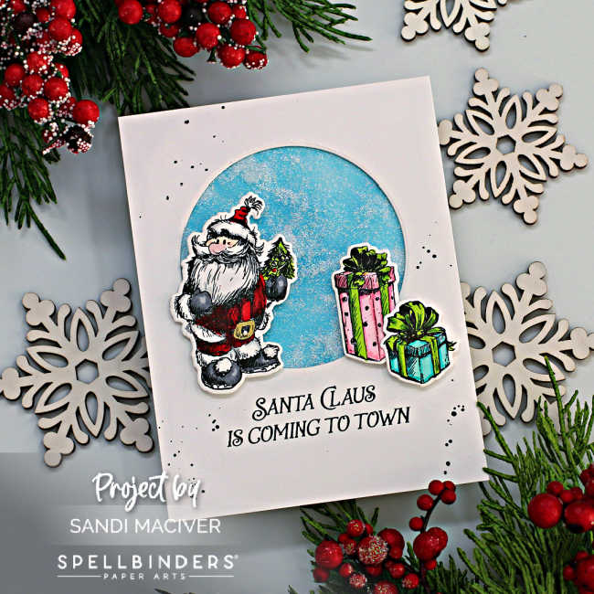 white hand made christmas card with a circle cut out and glitter shaker inside with a hand sketched santa overlay and pink and turquoise parcels