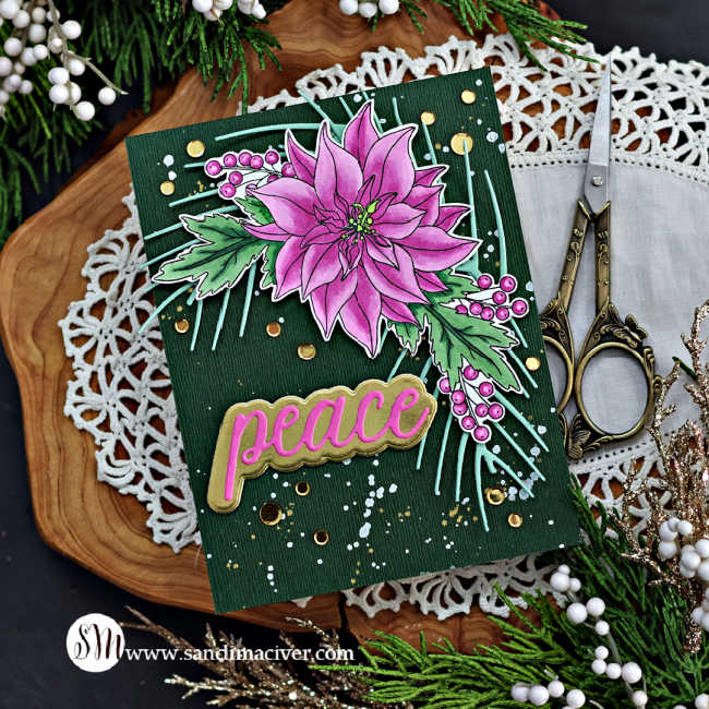 hand made christmas card with a dark green background splattered with white and gold paint, and overlay of a pink poinsettia spray with mint green leaves and a die cut sentiment saying peace.