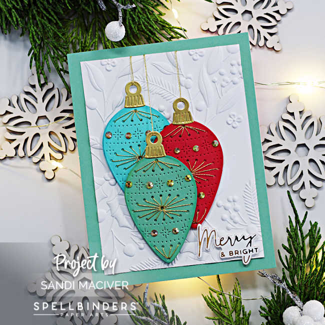 hand made christmas card with three large stitched ornaments in green, red and blue over a white embossed background