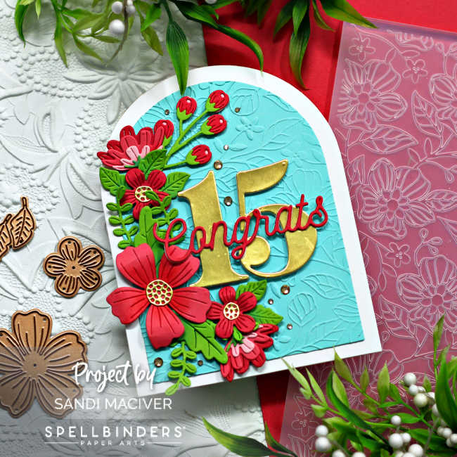 turquoise and white arched shaped card with a cascade of pink flowers and green leaves down the left side and the number 15 in gold in the center with congrats across the center