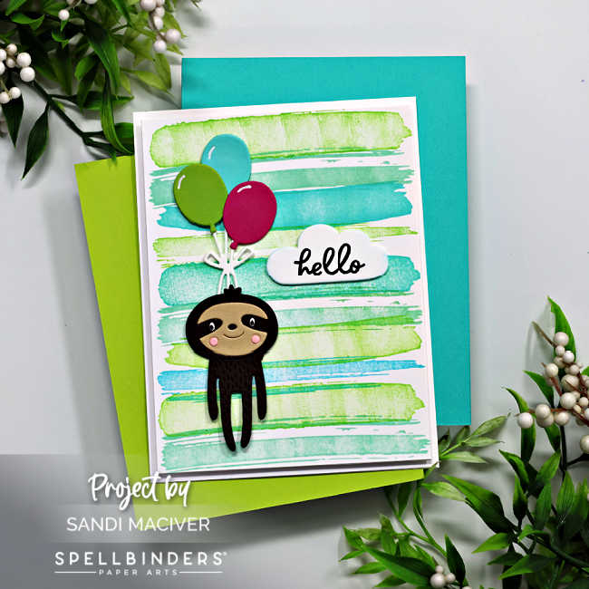 hand made child's card with a blue and green paint brush looking background with a brown die cut sloth floating in the sky by holding onto red, blue and green balloons