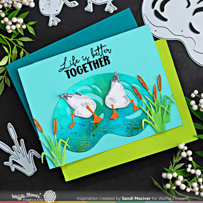 hand made card with a pale green background, a die cut pond in green and blue, with two white and gray duck butts sticking up surrounded by bull rushes