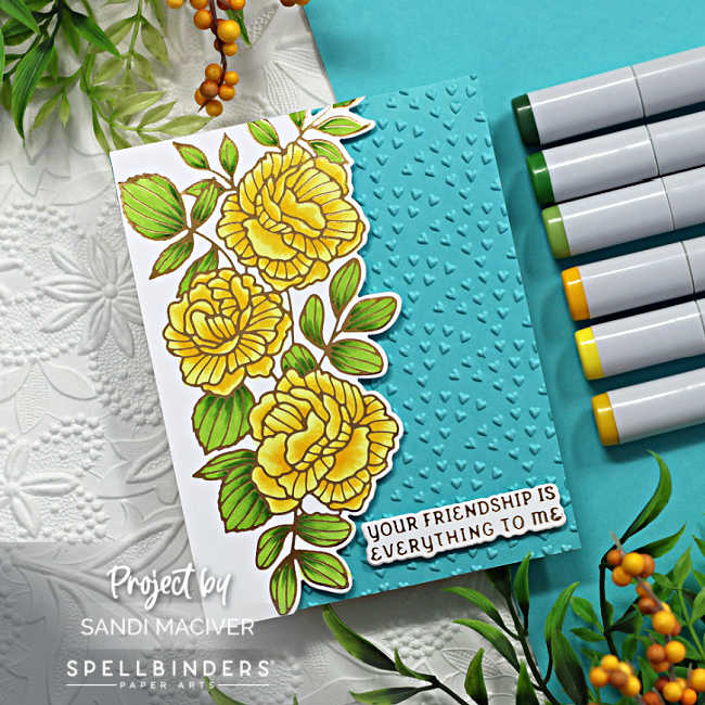 turquoise colored hand made card with a cascading floral design down the left side with copic colored yellow flowers and gold glimmer outline