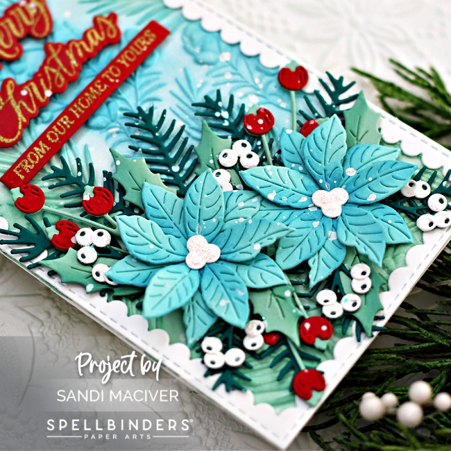 blue white and red holiday card with blue poinsettia, green holly and red berries on a embossed background with a white border